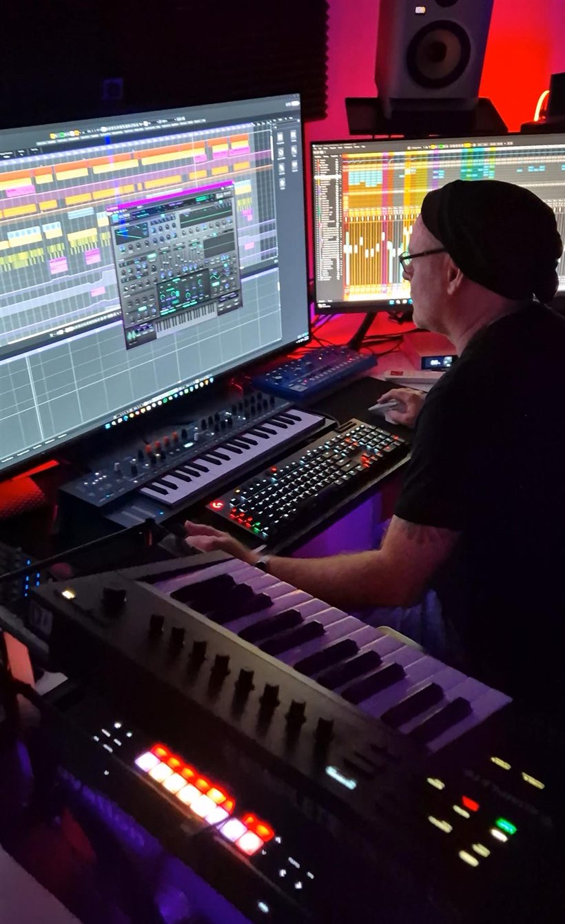 SYNKD producing at the synths in the studio
